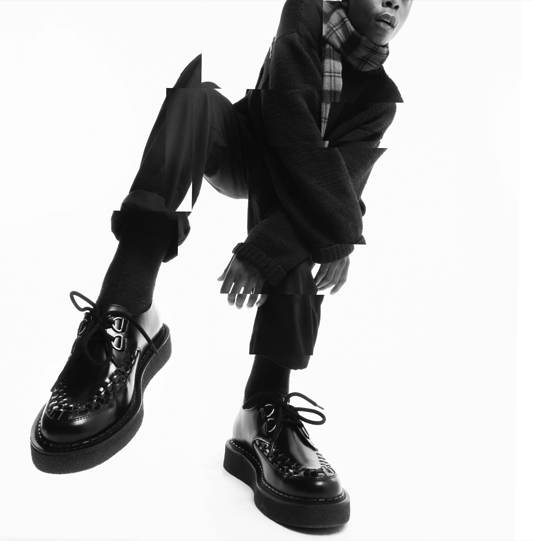 Model leaning over wearing black Hatton Creepers