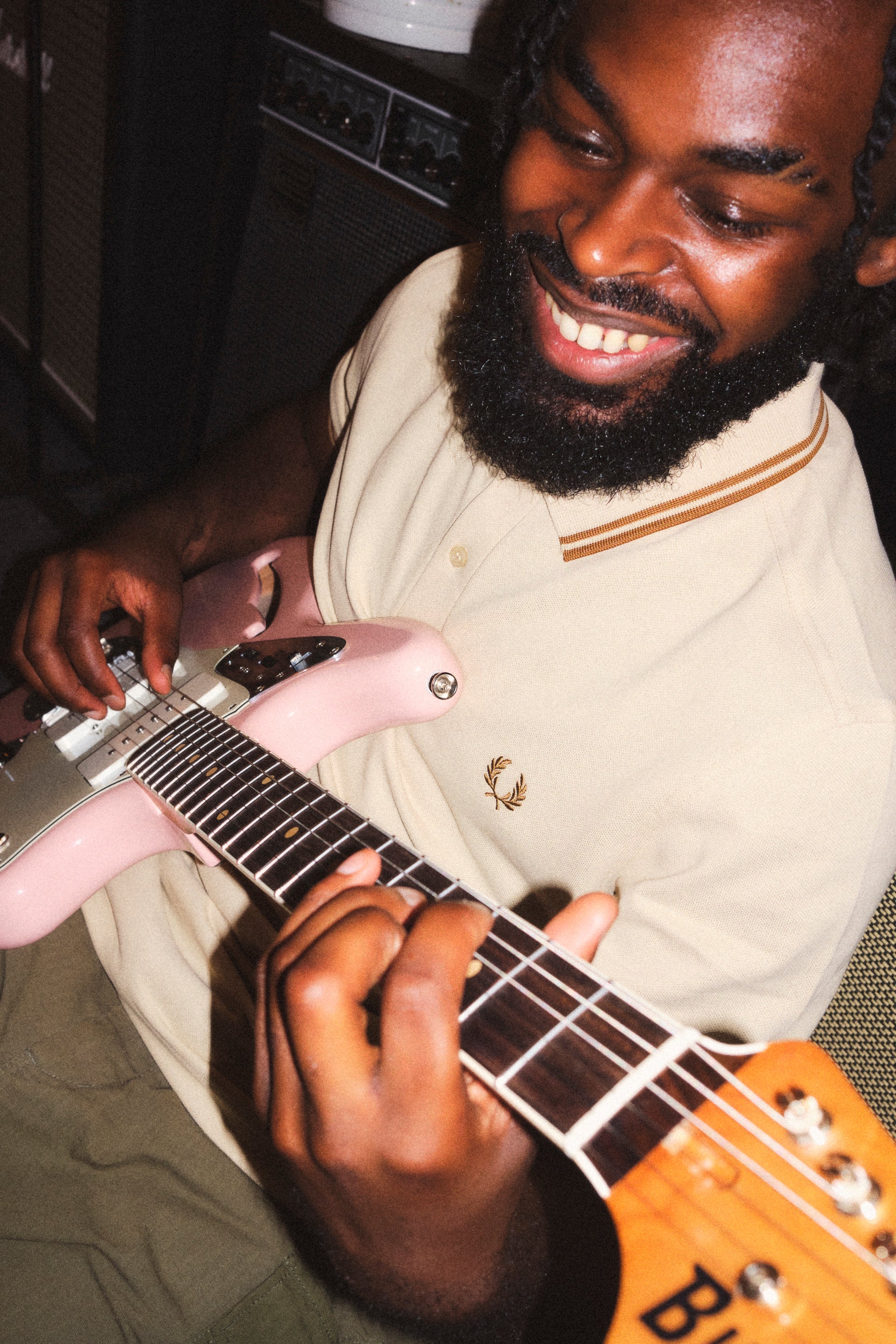 <p>Playing on </p><p>one of his guitars</p>