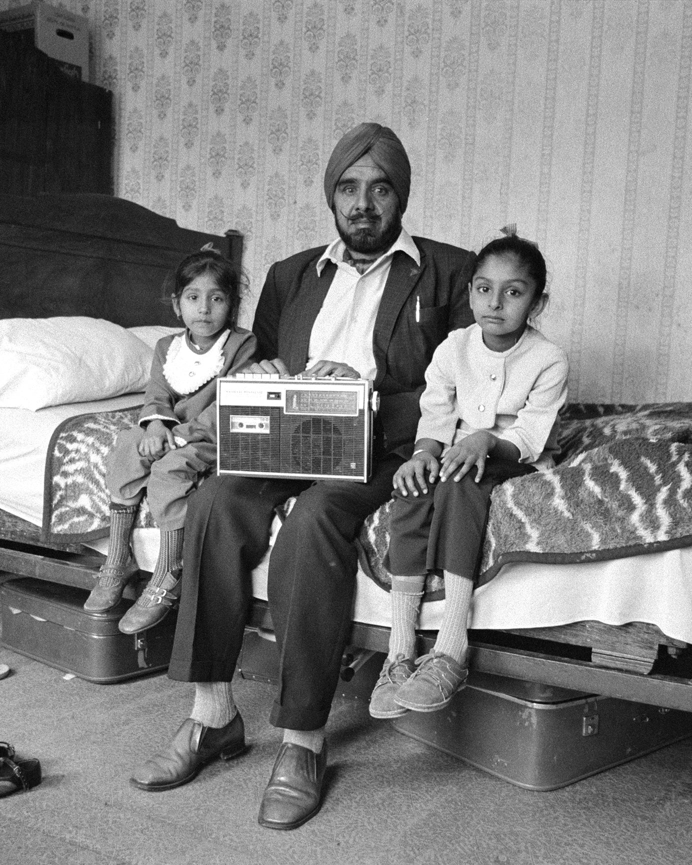 <p>Dennis Morris: Man with his two daughters and his most prized possession, Southall, 1976 (Copyright © Dennis Morris)</p><p></p>