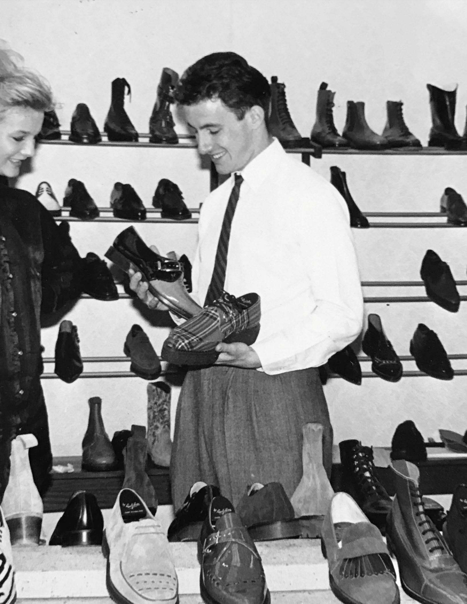 Archive image of Adam Waterfield holding shoes at a trade fair