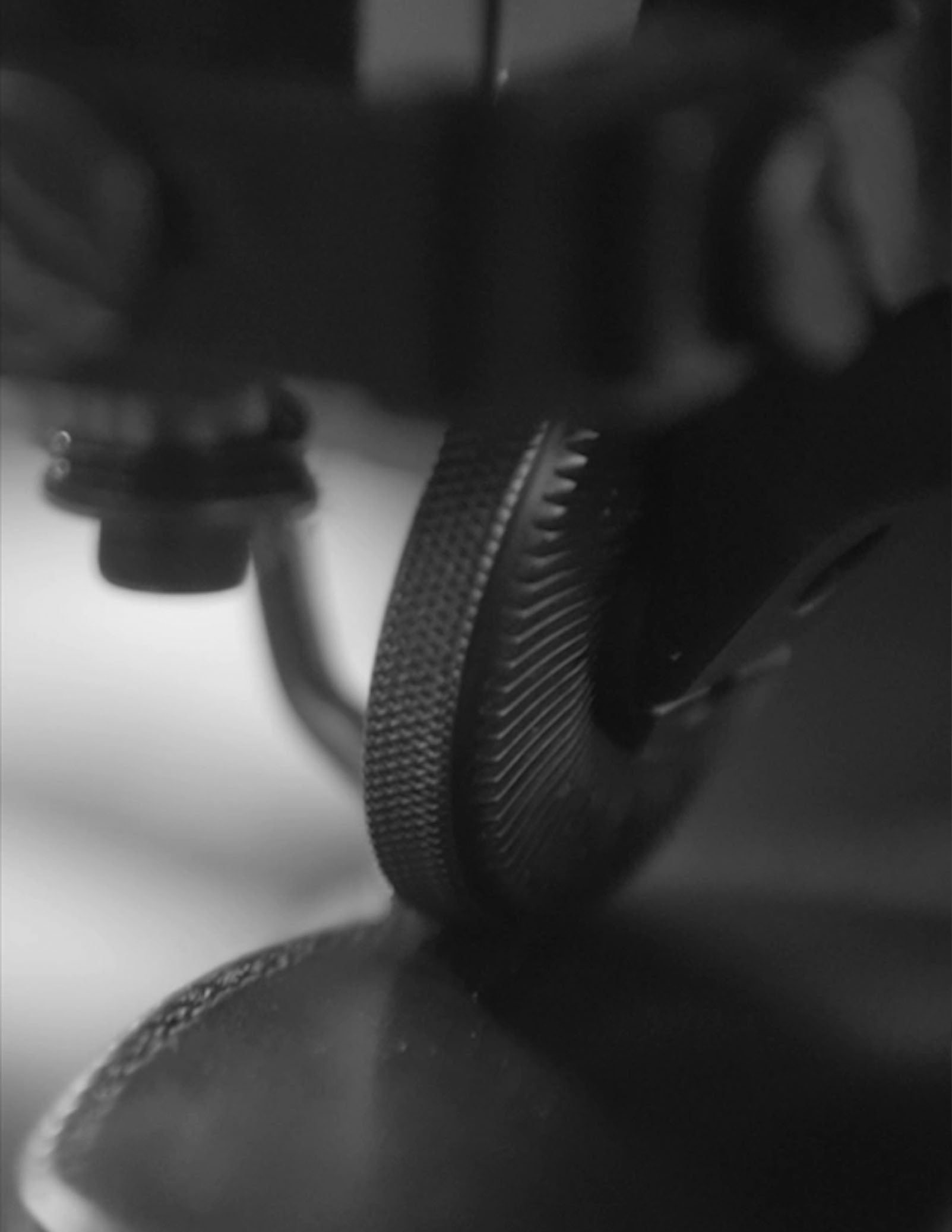 Close up of a sewing machine stitching a piece of leather
