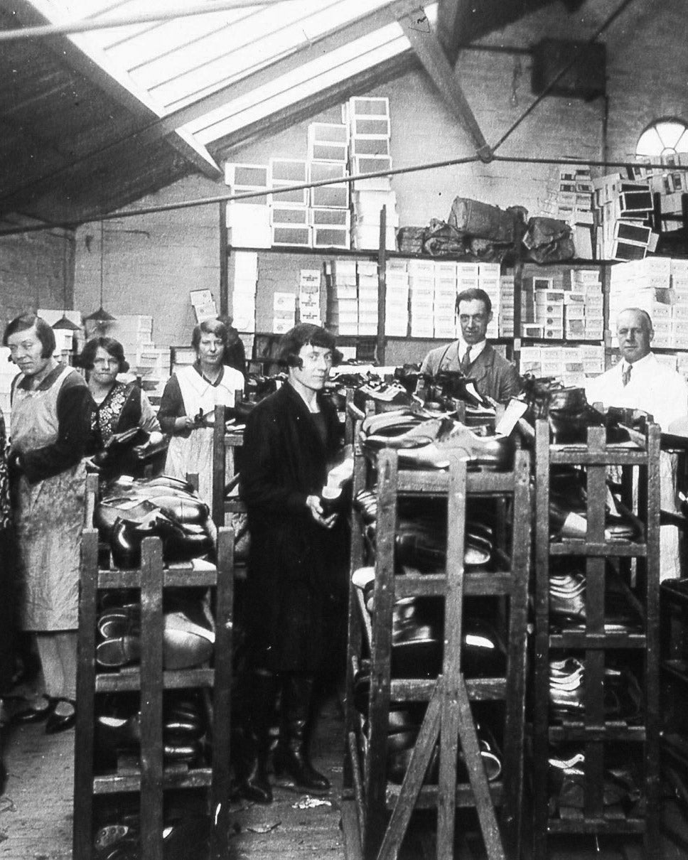 Workers pose for a photo in the original George Cox factory